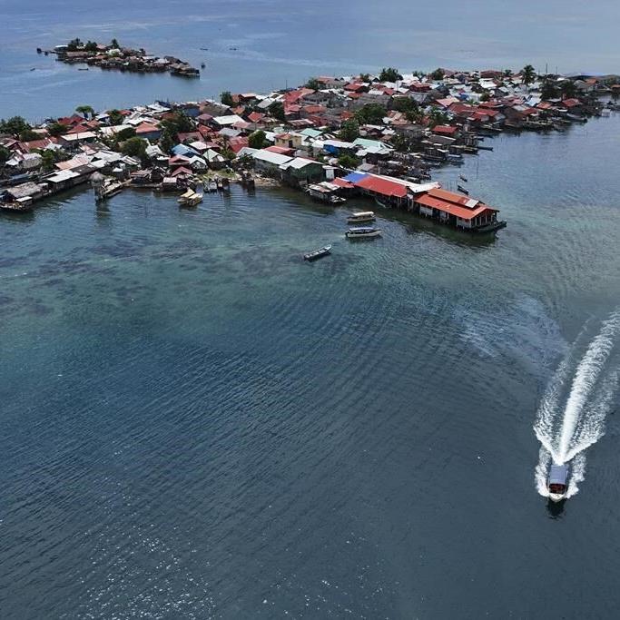 Panama community pushed from Caribbean island by rising sea levels moves into new houses